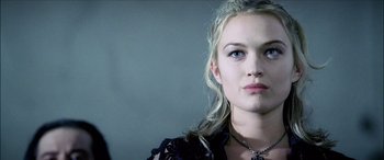 Movie still from “Underworld” (2003), directed by Len Wiseman – A beautiful young lady wearing a black shirt; Close Up shot, Low angle