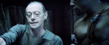 Movie still from “Underworld” (2003), directed by Len Wiseman – An older man with glasses and a beard; Close Up shot, Over the shoulder angle