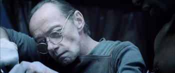 Movie still from “Underworld” (2003), directed by Len Wiseman – A person wearing glasses; Close Up shot, High angle