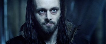 Movie still from “Underworld” (2003), directed by Len Wiseman – A person with long hair and a beard; Close Up shot, Low angle