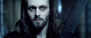 Movie still from “Underworld” (2003), directed by Len Wiseman – A person with long hair and blue eyes; Close Up shot, Low angle