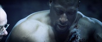 Movie still from “Underworld” (2003), directed by Len Wiseman – A man with a beard is looking down at his face; Extreme Close Up shot, Low angle