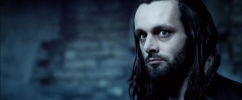 Movie still from “Underworld” (2003), directed by Len Wiseman – A person with long hair and a beard; Close Up shot, Low angle