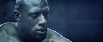 Movie still from “Underworld” (2003), directed by Len Wiseman – A man's face in a dark room; Close Up shot, Low angle