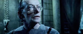 Movie still from “Underworld” (2003), directed by Len Wiseman – An old man wearing glasses and holding a pipe in his mouth; Close Up shot, Low angle