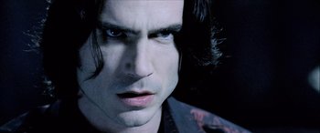 Movie still from “Underworld” (2003), directed by Len Wiseman – A person with long black hair; Close Up shot, High angle