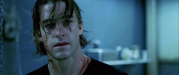 Movie still from “Underworld” (2003), directed by Len Wiseman – A person with a wound on his face; Close Up shot, Low angle