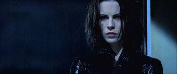Movie still from “Underworld” (2003), directed by Len Wiseman – A person wearing a black outfit; Close Up shot, Low angle