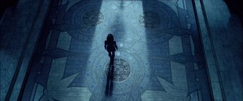 Movie still from “Underworld” (2003), directed by Len Wiseman – A person standing on a tiled floor in the middle of the night; Wide shot, Overhead angle