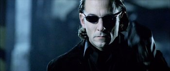 Movie still from “Underworld” (2003), directed by Len Wiseman – A person wearing sunglasses and a jacket; Close Up shot, Low angle
