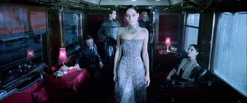 Movie still from “Underworld” (2003), directed by Len Wiseman – A woman in a dress standing on a train; Medium shot, Low angle