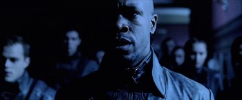 Movie still from “Underworld” (2003), directed by Len Wiseman – A man in a leather jacket looking at the camera; Close Up shot, Low angle
