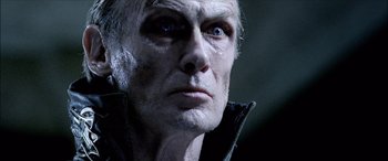 Movie still from “Underworld” (2003), directed by Len Wiseman – An old man with a very dark face looking into the distance; Close Up shot, Low angle