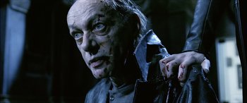 Movie still from “Underworld” (2003), directed by Len Wiseman – An older man with a knife in his hand; Close Up shot, Low angle