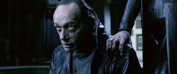 Movie still from “Underworld” (2003), directed by Len Wiseman – An old man is holding a knife in his right hand; Close Up shot, Over the shoulder angle