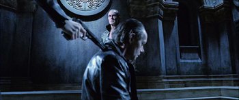Movie still from “Underworld” (2003), directed by Len Wiseman – A man holding a sword in front of another man; Medium shot, Over the shoulder angle