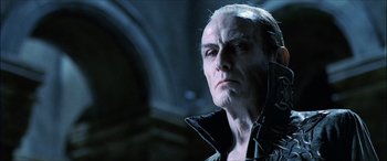 Movie still from “Underworld” (2003), directed by Len Wiseman – An old man with white hair is looking at the camera; Close Up shot, Low angle