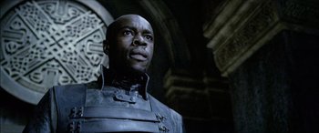 Movie still from “Underworld” (2003), directed by Len Wiseman – A man standing in front of a building; Close Up shot, Low angle