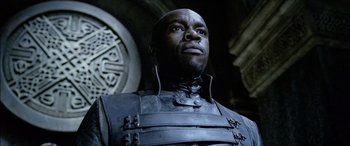 Movie still from “Underworld” (2003), directed by Len Wiseman – A man in a leather jacket looking upward; Close Up shot, Low angle