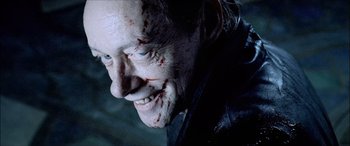 Movie still from “Underworld” (2003), directed by Len Wiseman – A person with blood all over his face; Close Up shot, Over the shoulder angle