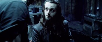 Movie still from “Underworld” (2003), directed by Len Wiseman – A person with long hair and a beard; Close Up shot, High angle