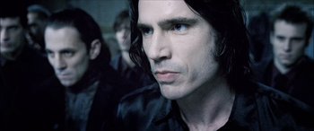 Movie still from “Underworld” (2003), directed by Len Wiseman – A person with long black hair; Close Up shot, Over the shoulder angle