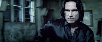 Movie still from “Underworld” (2003), directed by Len Wiseman – A person wearing a black shirt; Close Up shot, Low angle