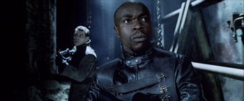 Movie still from “Underworld” (2003), directed by Len Wiseman – A man in a black leather jacket and a man in a black leather jacket; Close Up shot, Low angle