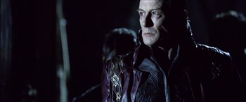 Movie still from “Underworld” (2003), directed by Len Wiseman – A man wearing a leather jacket and a tie; Close Up shot, Over the shoulder angle