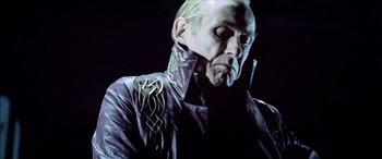 Movie still from “Underworld” (2003), directed by Len Wiseman – An older man wearing a leather jacket with a design on it; Close Up shot, Low angle