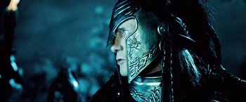 Movie still from “Underworld: Evolution” (2006), directed by Len Wiseman – A person wearing a metal helmet; Close Up shot, Over the shoulder angle