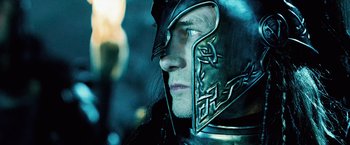 Movie still from “Underworld: Evolution” (2006), directed by Len Wiseman – A person wearing a metal helmet; Close Up shot, Over the shoulder angle