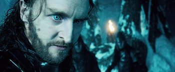 Movie still from “Underworld: Evolution” (2006), directed by Len Wiseman – A person with a beard and blue eyes; Close Up shot, Low angle