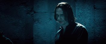 Movie still from “Underworld: Evolution” (2006), directed by Len Wiseman – A person with long hair wearing a tie; Close Up shot, Over the shoulder angle