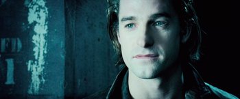 Movie still from “Underworld: Evolution” (2006), directed by Len Wiseman – A man's face in a dark room; Close Up shot, Over the shoulder angle