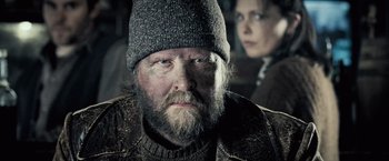 Movie still from “Underworld: Evolution” (2006), directed by Len Wiseman – An old man with a beard wearing a hat; Close Up shot, Over the shoulder angle