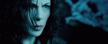 Movie still from “Underworld: Evolution” (2006), directed by Len Wiseman – A woman's face in the dark; Close Up shot, Low angle
