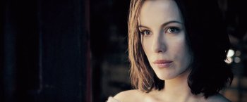 Movie still from “Underworld: Evolution” (2006), directed by Len Wiseman – A woman's face in the sunlight; Close Up shot, Over the shoulder angle