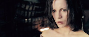 Movie still from “Underworld: Evolution” (2006), directed by Len Wiseman – A person with short hair; Close Up shot, Over the shoulder angle