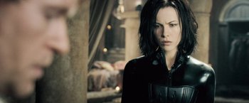 Movie still from “Underworld: Evolution” (2006), directed by Len Wiseman – A person wearing a black jacket; Close Up shot, Over the shoulder angle