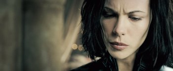 Movie still from “Underworld: Evolution” (2006), directed by Len Wiseman – A woman's face in a leather jacket; Close Up shot, Low angle
