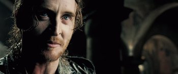 Movie still from “Underworld: Evolution” (2006), directed by Len Wiseman – A person with a beard; Close Up shot, Over the shoulder angle