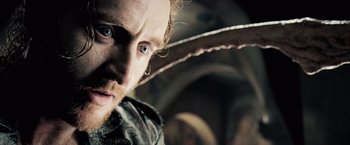 Movie still from “Underworld: Evolution” (2006), directed by Len Wiseman – A man with long hair and blue eyes looking at the camera; Close Up shot, Low angle