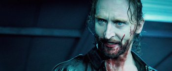 Movie still from “Underworld: Evolution” (2006), directed by Len Wiseman – A person with blood on his face; Close Up shot, Over the shoulder angle