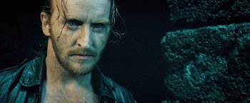 Movie still from “Underworld: Evolution” (2006), directed by Len Wiseman – A person with a beard; Close Up shot, Over the shoulder angle