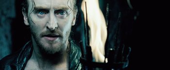 Movie still from “Underworld: Evolution” (2006), directed by Len Wiseman – A person with a beard; Close Up shot, Over the shoulder angle