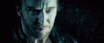 Movie still from “Underworld: Evolution” (2006), directed by Len Wiseman – Close up of a man with a beard and blue eyes looking at the camera; Close Up shot, Over the shoulder angle