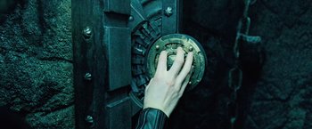 Movie still from “Underworld: Evolution” (2006), directed by Len Wiseman – A hand is holding a piece of metal; Extreme Close Up shot, High angle