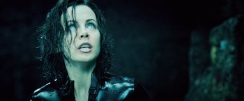 Movie still from “Underworld: Evolution” (2006), directed by Len Wiseman – A person with wet hair and blue eyes; Close Up shot, Over the shoulder angle