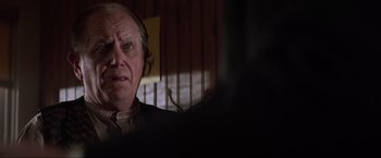 Movie still from “Unforgiven” (1992), directed by Clint Eastwood – An old man with a beard and mustache looking at the camera; Close Up shot, Over the shoulder angle